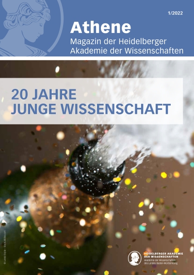 Titelbild des Athene Magazins mit spritzender Sektflasche und Titel: 20 Jahre Junge Wissenschaft 