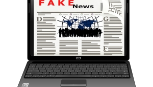 Animation eines aufgeklappten Laptops, auf dem eine Online-Zeitung dargestellt ist, die die Überschrift "FAKE News" trägt.