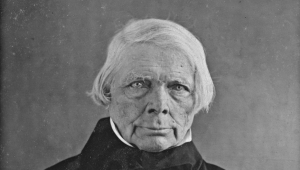 Brustbild in schwarzweiß von dem Philosophen Friedrich Wilhelm Joseph Schelling, der den Betrachter frontal ansieht.