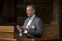 Der Sprecher des Wissenschaftlichen Nachwuchs Kollegs Dr. Martin Gerchen hält eine Rede. 
